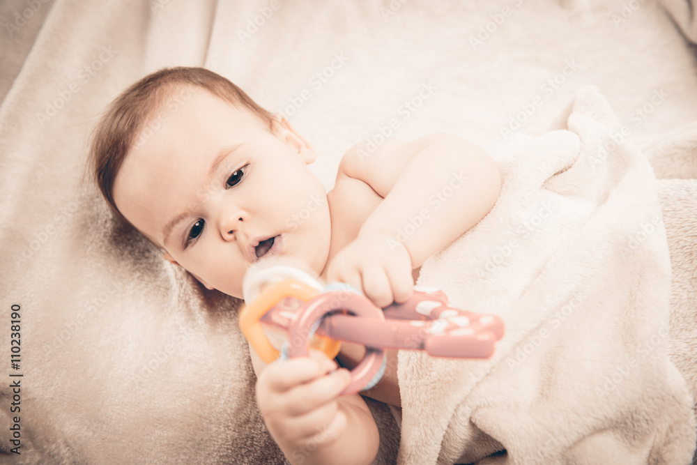 Small baby girl looking at toy Small baby girl looking at toy