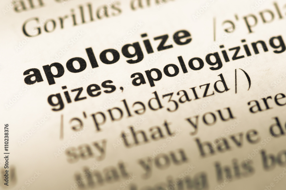 Close up of old English dictionary page with word apologize Close up of old English dictionary page with word apologize