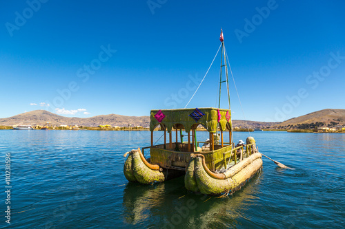 Lake Titicaca, Puno - August 15th 2013 - Local people living in their "totoro" boats and house in the floating island in the Lake Titicaca in Puno, Peru, South America