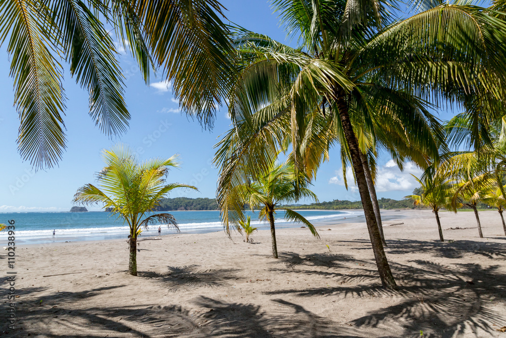 Beautiful blue sky day with a blue sea and empty sand. Playa Samara, Costa Rica, Central America. Beautiful blue sky day with a blue sea and empty sand. Playa Samara, Costa Rica, Central America.