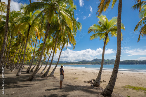 Beautiful blue sky day with a blue sea and empty sand. Playa Samara, Costa Rica, Central America. photo