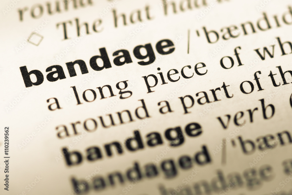 Close up of old English dictionary page with word bandage Close up of old English dictionary page with word bandage