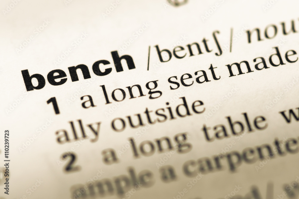 Close up of old English dictionary page with word bench Close up of old English dictionary page with word bench