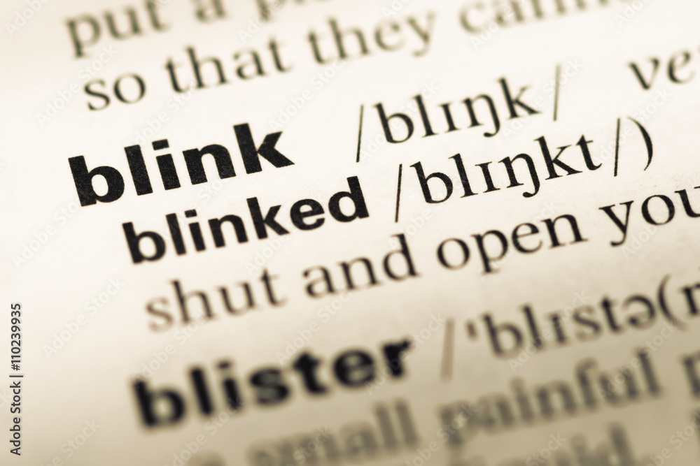 Obraz premium Close up of old English dictionary page with word blink