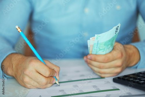 Man working on financial report at the office, close-up