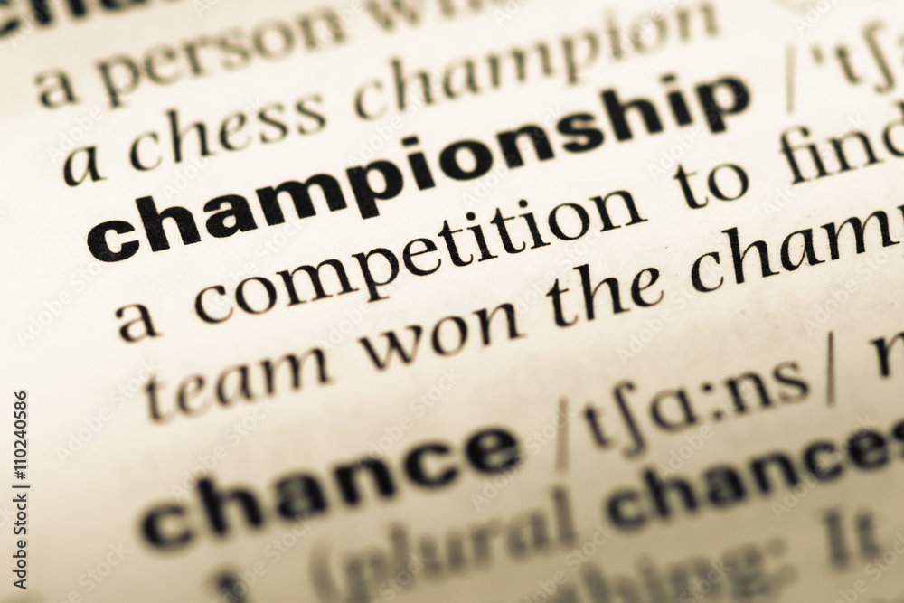 Obraz premium Close up of old English dictionary page with word championship