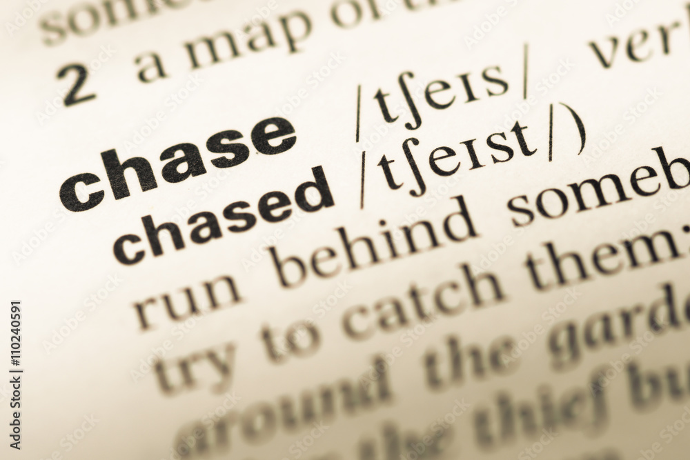 Fototapeta premium Close up of old English dictionary page with word chase
