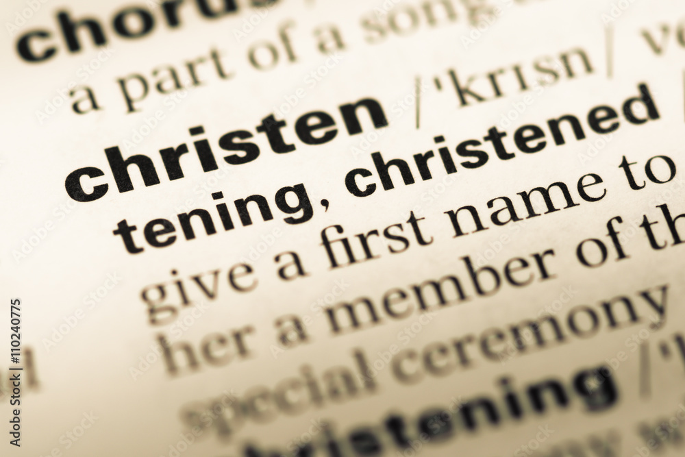 Close up of old English dictionary page with word christen Close up of old English dictionary page with word christen