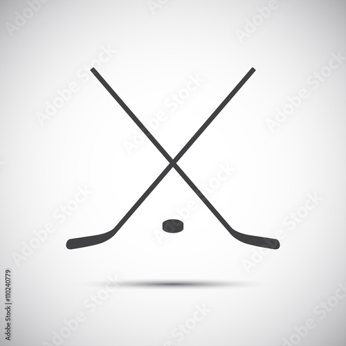Simple crossed hockey stick with puck, vector icon