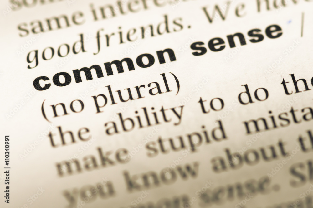 Close up of old English dictionary page with word common sense Close up of old English dictionary page with word common sense