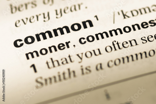 Close up of old English dictionary page with word common