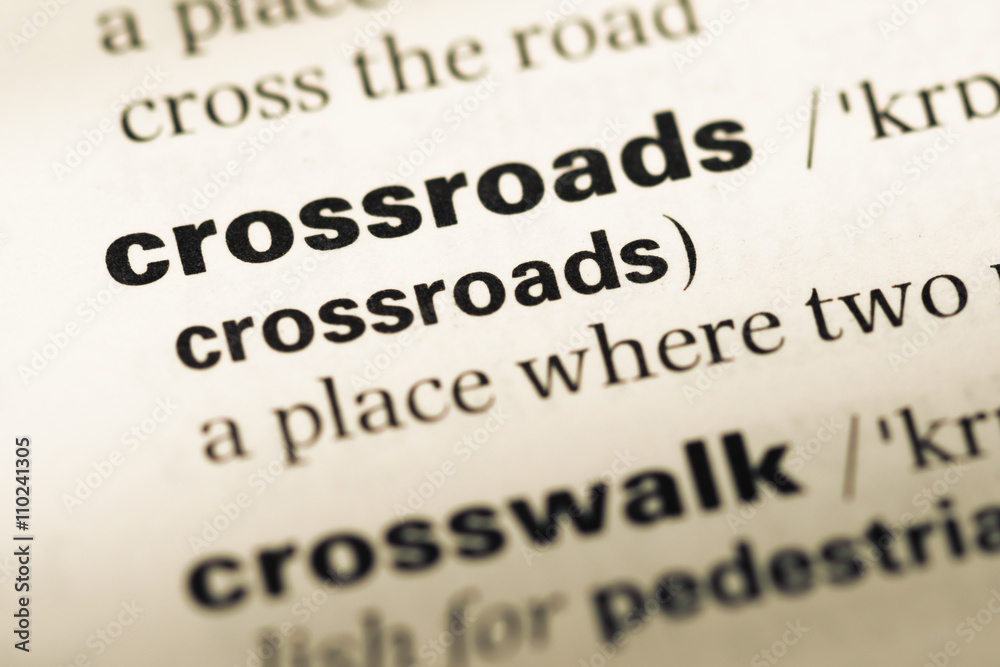 Close up of old English dictionary page with word crossroads Close up of old English dictionary page with word crossroads