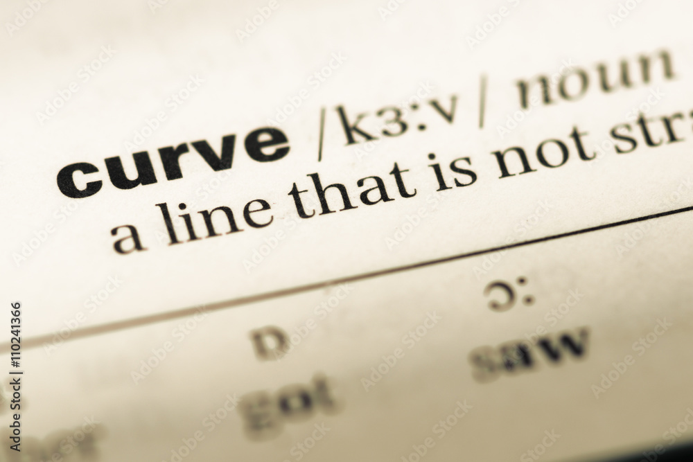 Close up of old English dictionary page with word curve Close up of old English dictionary page with word curve