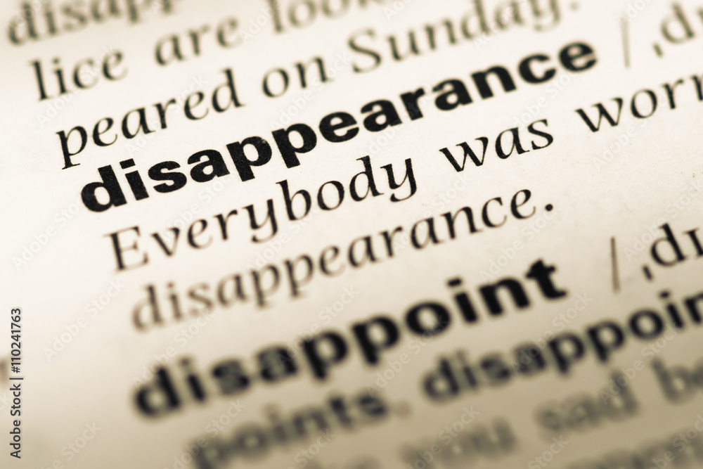 Obraz premium Close up of old English dictionary page with word disappearance