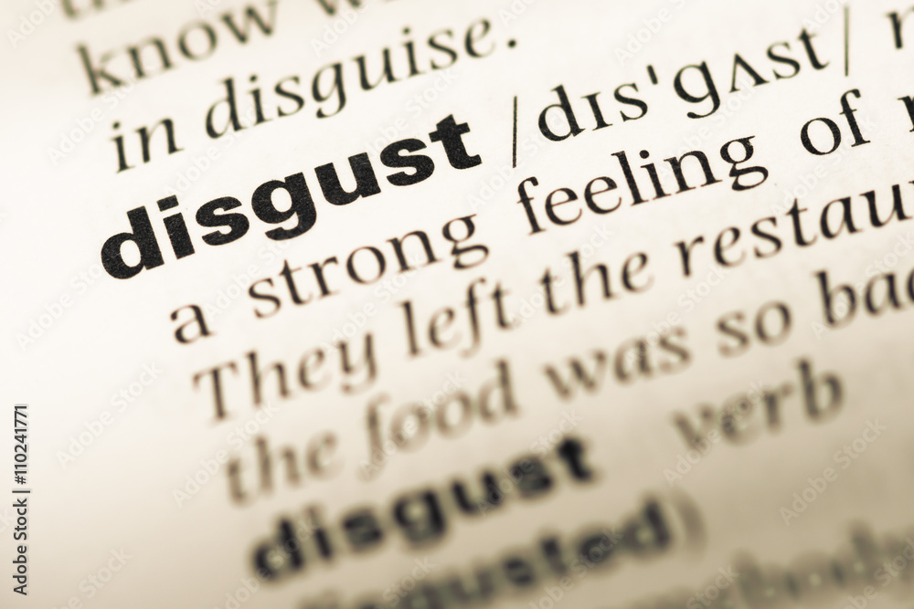 Close up of old English dictionary page with word disgust Close up of old English dictionary page with word disgust