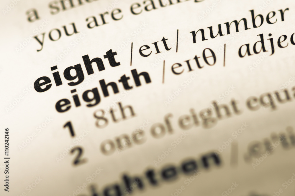Obraz premium Close up of old English dictionary page with word eight