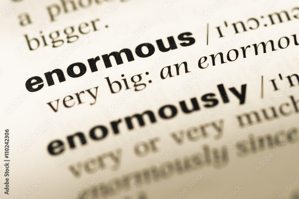 Close up of old English dictionary page with word enormous Close up of old English dictionary page with word enormous