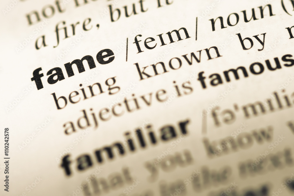 Close up of old English dictionary page with word fame