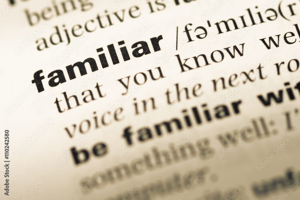 Close up of old English dictionary page with word familiar Close up of old English dictionary page with word familiar