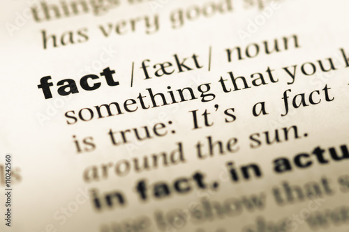Close up of old English dictionary page with word fact photo