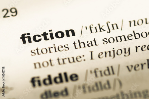 Close up of old English dictionary page with word fiction