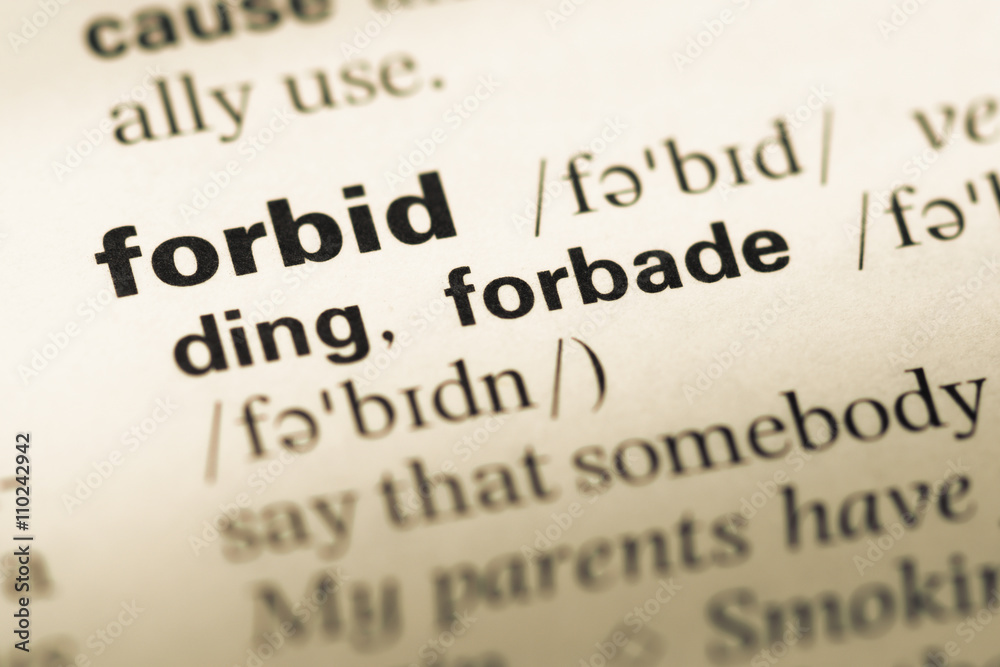 Close up of old English dictionary page with word forbid