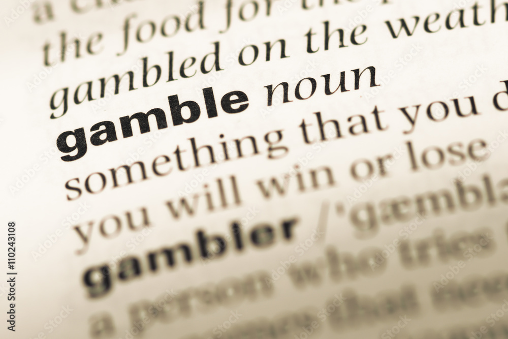 Close up of old English dictionary page with word gamble