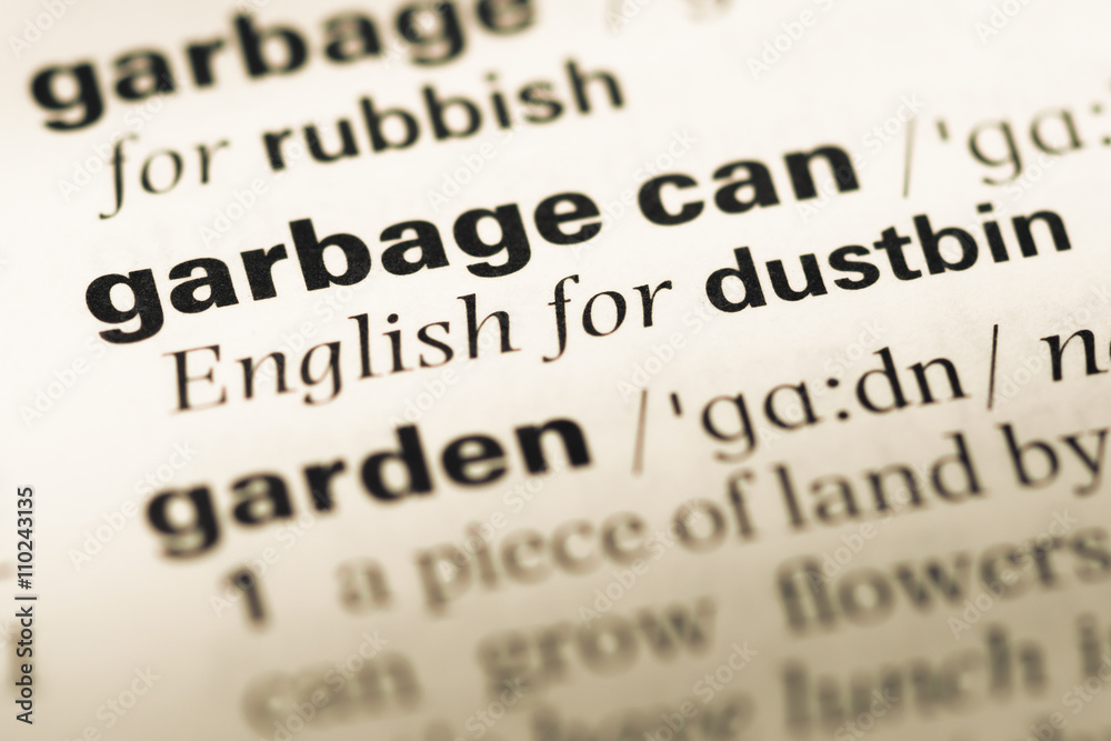 Close up of old English dictionary page with word garbage can Close up of old English dictionary page with word garbage can