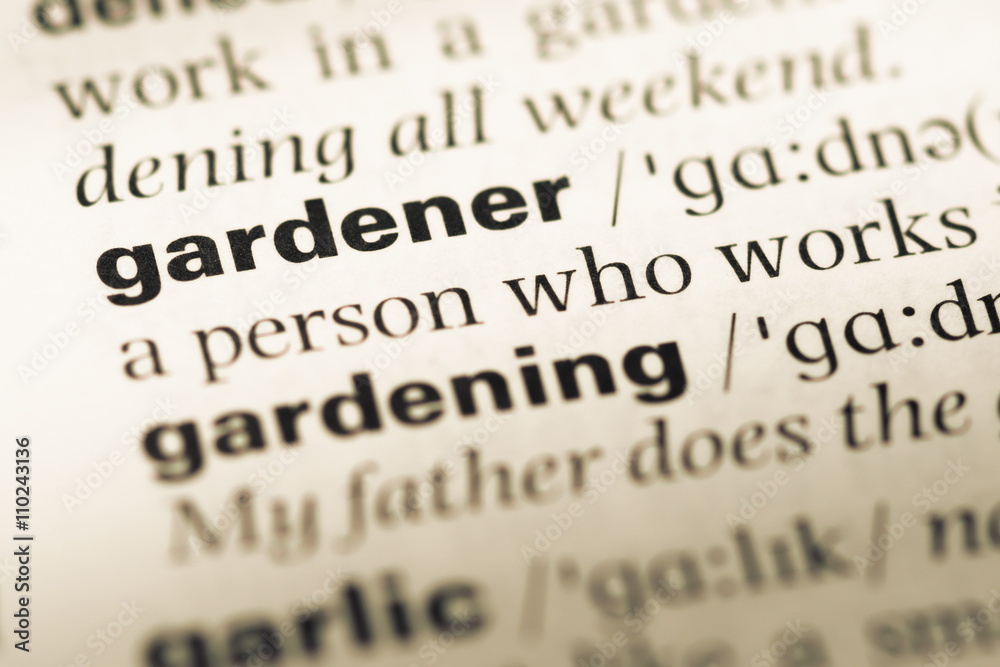 Close up of old English dictionary page with word gardener Close up of old English dictionary page with word gardener