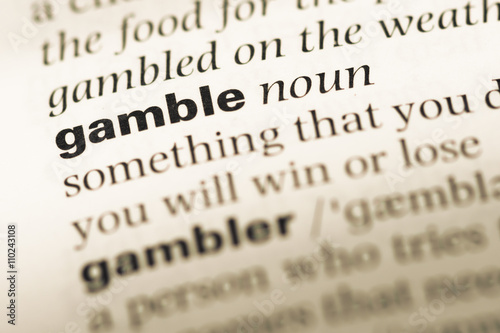 Close up of old English dictionary page with word gamble