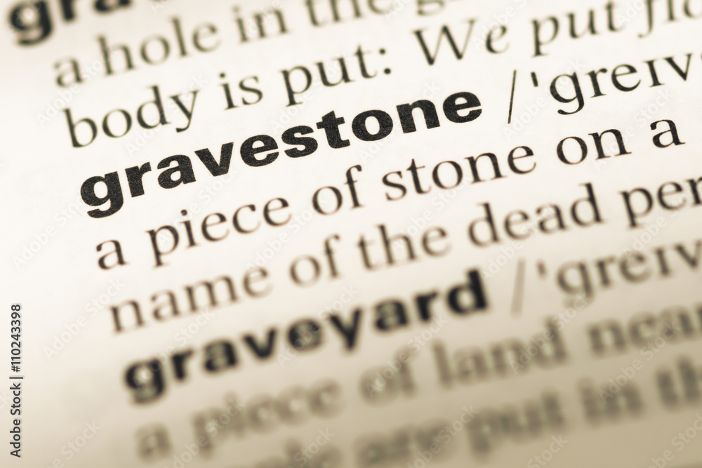 Close up of old English dictionary page with word gravestone Close up of old English dictionary page with word gravestone
