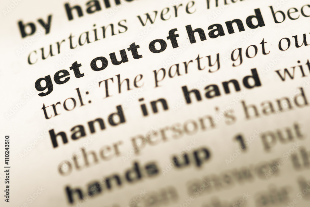 Close up of old English dictionary page with word get out of han Close up of old English dictionary page with word get out of han
