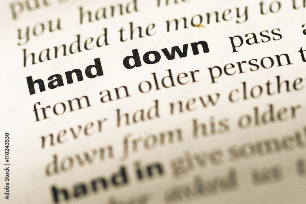 Close up of old English dictionary page with word hand down Close up of old English dictionary page with word hand down