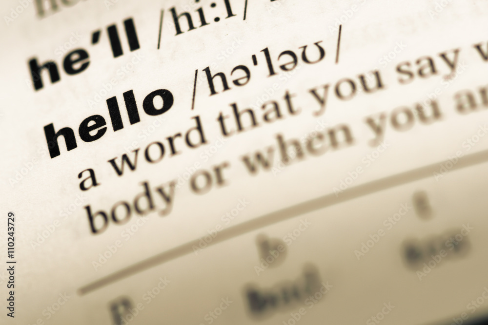 Close up of old English dictionary page with word hello