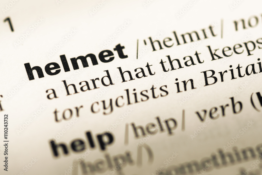 Close up of old English dictionary page with word helmet Close up of old English dictionary page with word helmet
