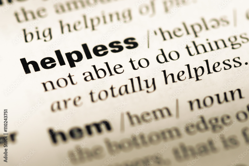Close up of old English dictionary page with word helpless Close up of old English dictionary page with word helpless