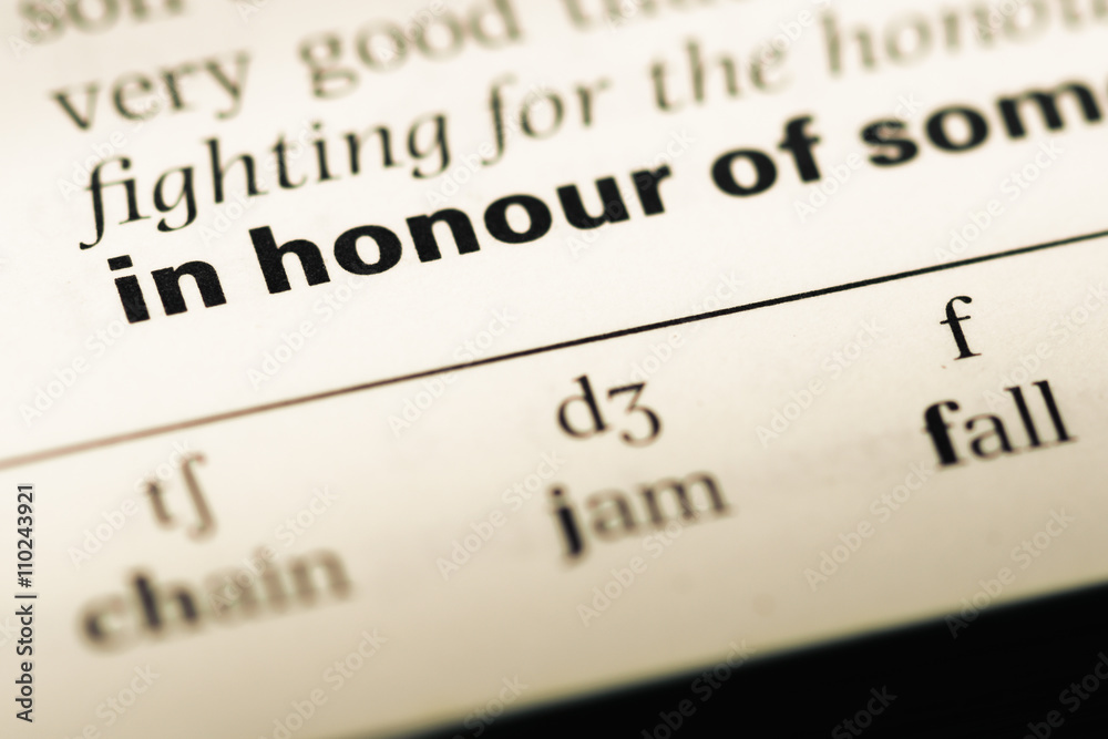 Close up of old English dictionary page with word in honour of Close up of old English dictionary page with word in honour of