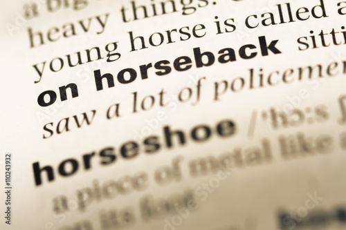 Close up of old English dictionary page with word on horseback