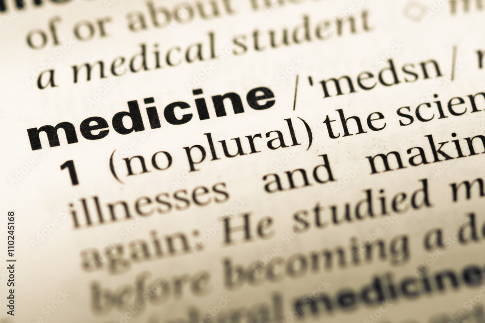 Close up of old English dictionary page with word medicine Close up of old English dictionary page with word medicine