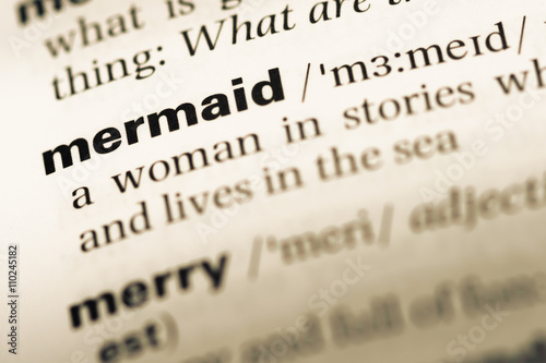 Close up of old English dictionary page with word mermaid