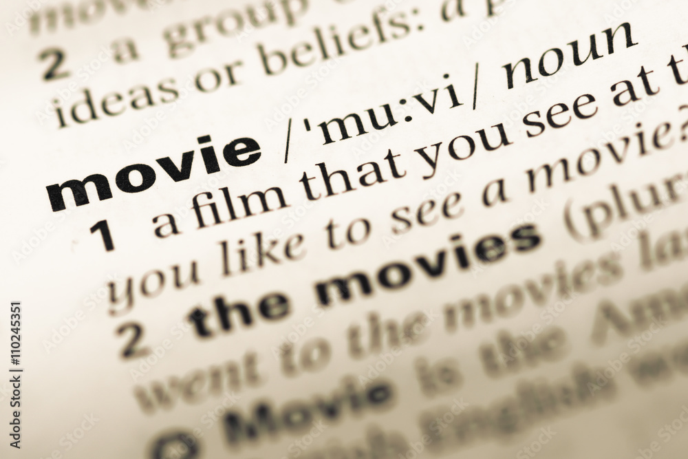 Close up of old English dictionary page with word movie Close up of old English dictionary page with word movie
