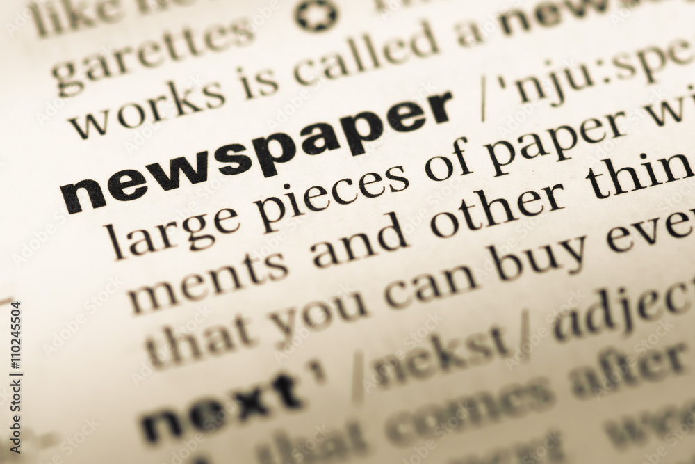 Close up of old English dictionary page with word newspaper Close up of old English dictionary page with word newspaper