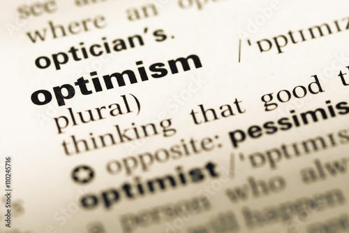 Close up of old English dictionary page with word optimism photo