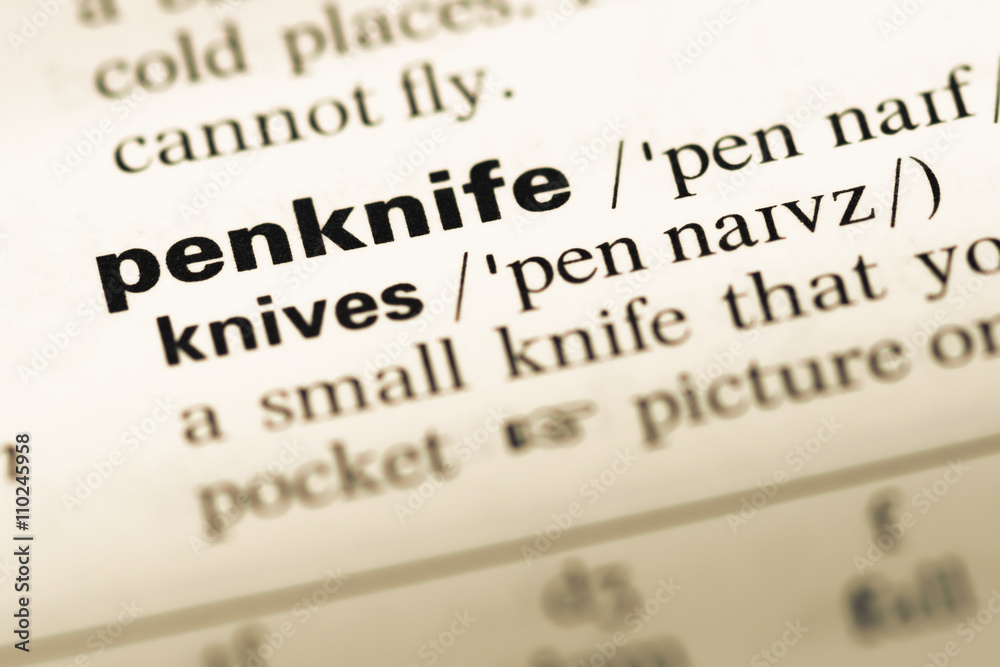 Close up of old English dictionary page with word penknife Close up of old English dictionary page with word penknife