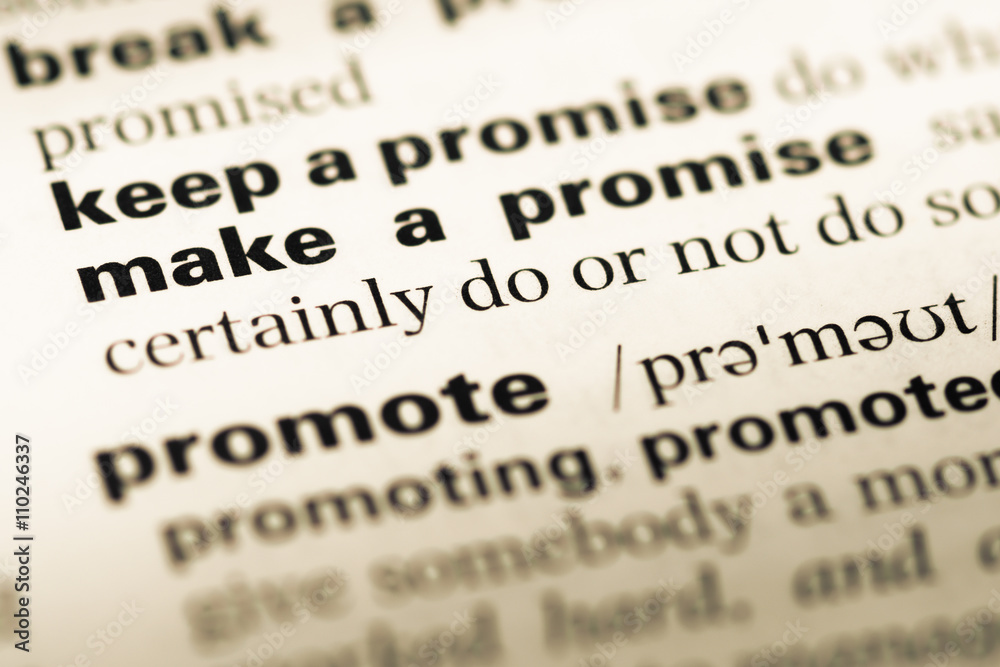 Close up of old English dictionary page with word make a promise Close up of old English dictionary page with word make a promise
