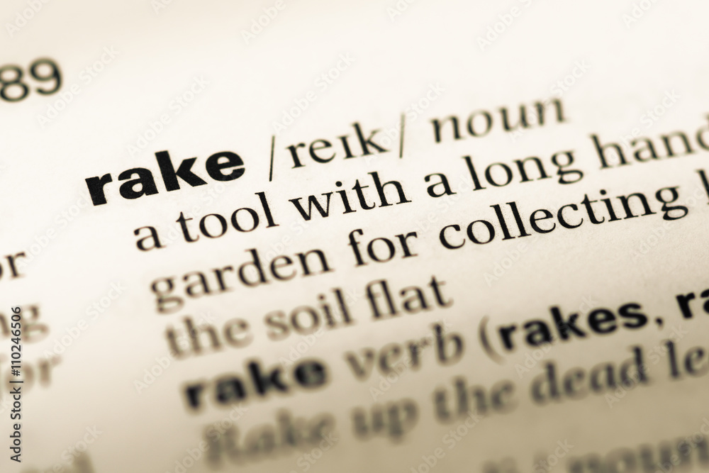 Obraz premium Close up of old English dictionary page with word rake