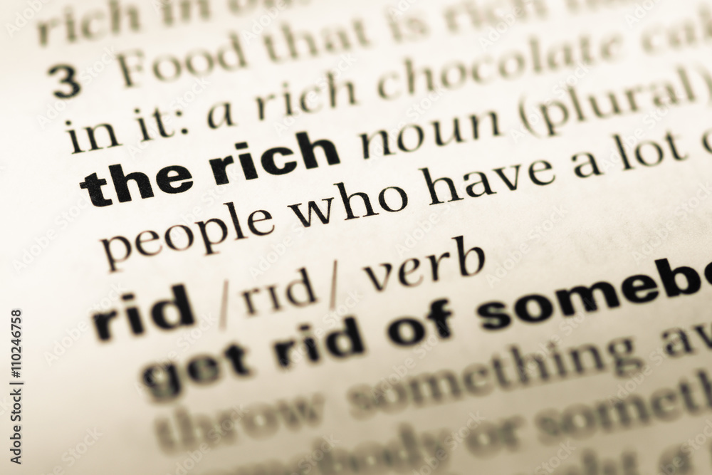 Close up of old English dictionary page with word the rich Close up of old English dictionary page with word the rich
