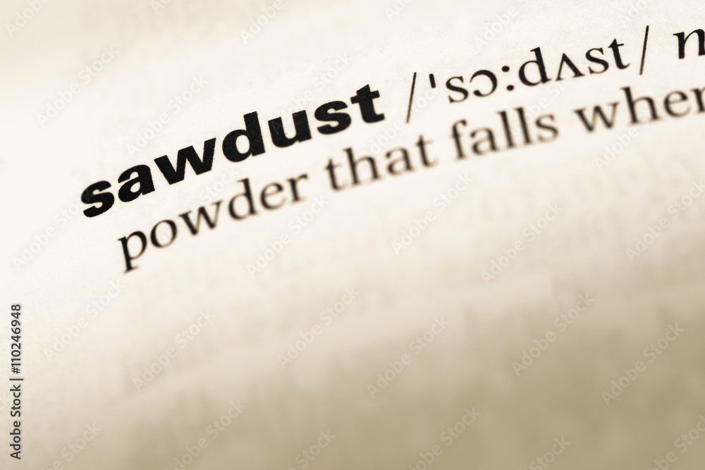 Obraz premium Close up of old English dictionary page with word sawdust