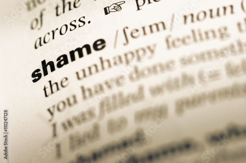 Close up of old English dictionary page with word shame photo