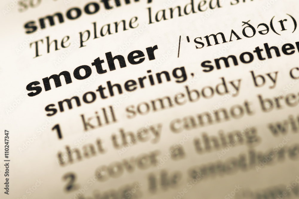 Close up of old English dictionary page with word smother Close up of old English dictionary page with word smother